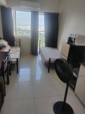 Condo with two single beds and balcony facing manila view